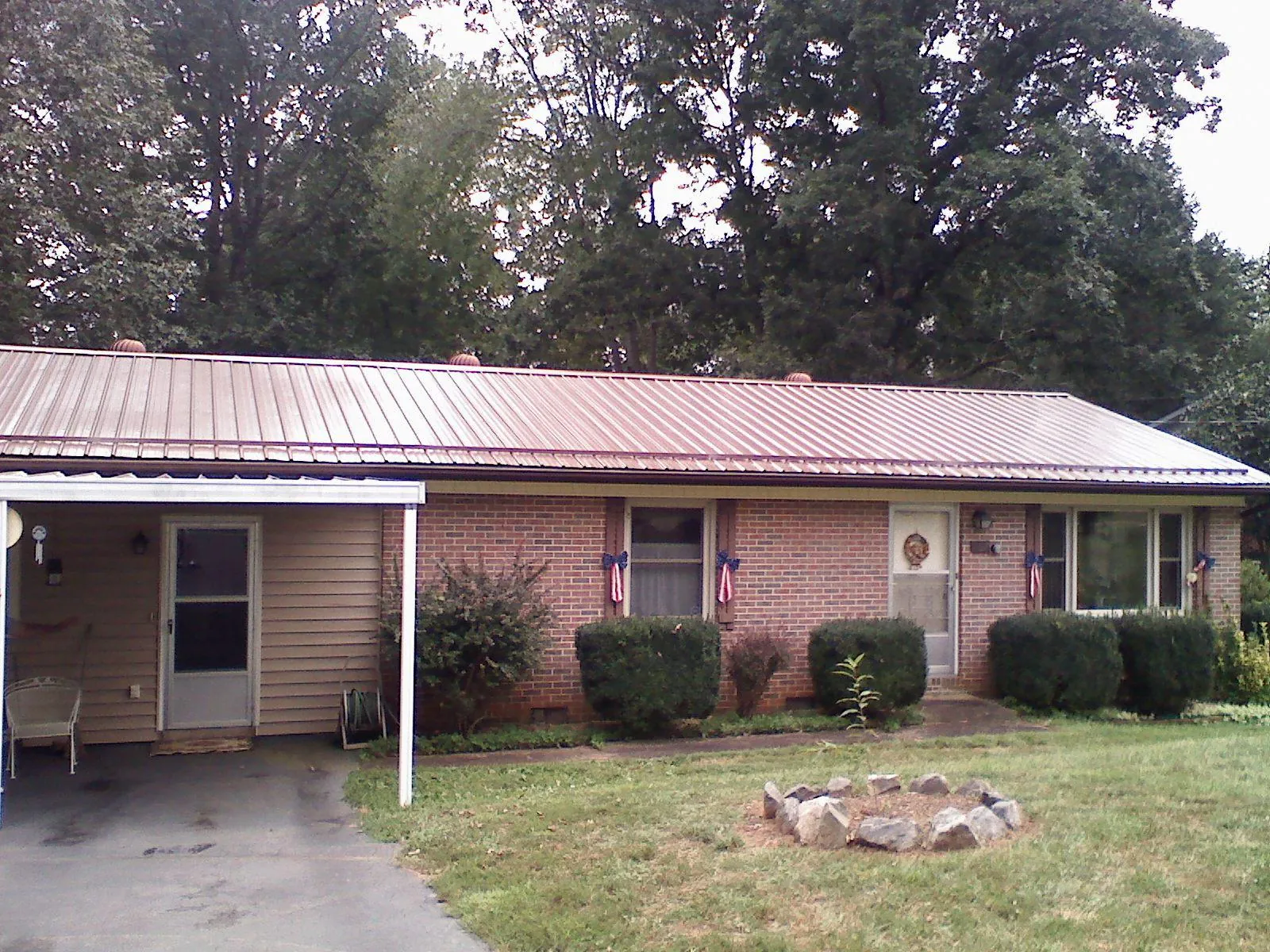 Bronze metal roof and carport on a brick ranch home — Roof Repair work by our crew in La Grange Park