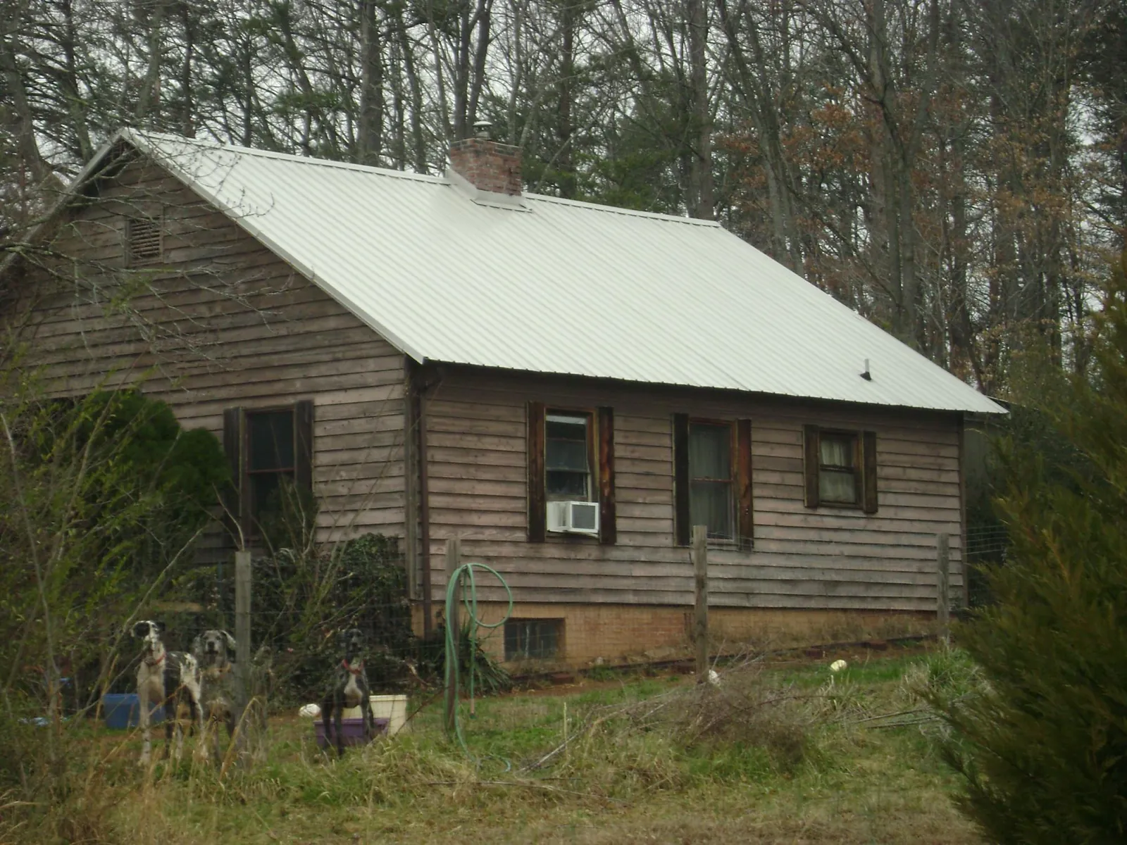 White metal roof on an old wood sided farmhouse, from a Metal Roof Installation job in La Grange Park